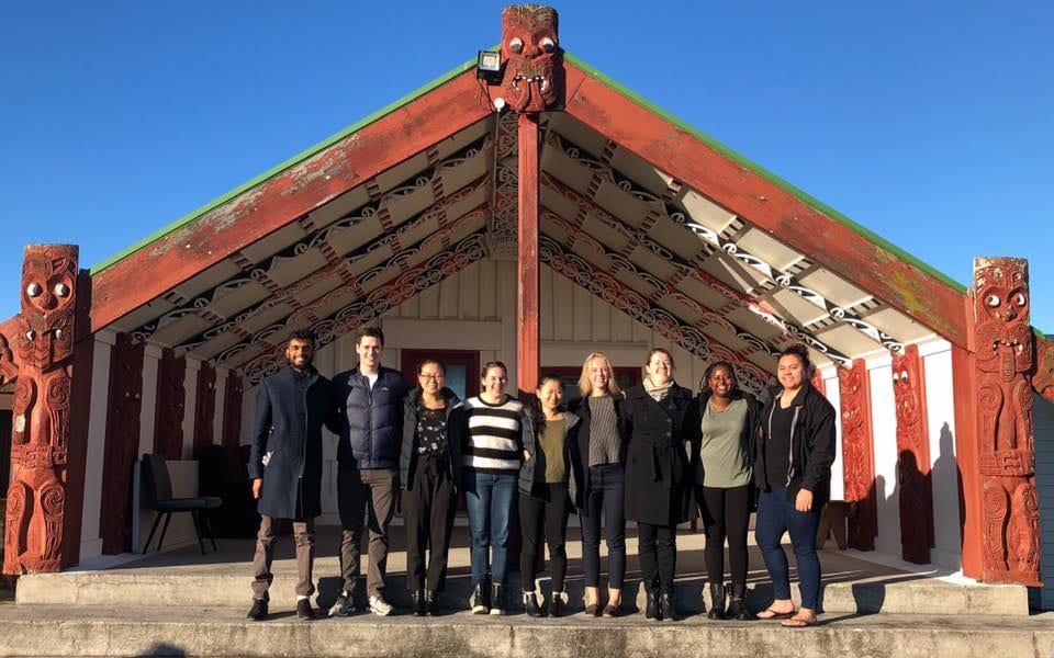 Photo: at Ohotu Marae, from Left - Deep Bedekar, Liam Davis, Aileen Zhou, Laura Makker, Alice Yu, Siska Falconer, Anna-Marie Rohs, Milka Thuo, Danika Tangi